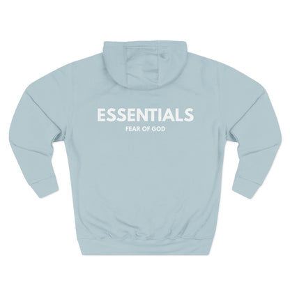 Light blue hoodie with 'ESSENTIALS' and 'FEAR OF GOD' text on a white background
