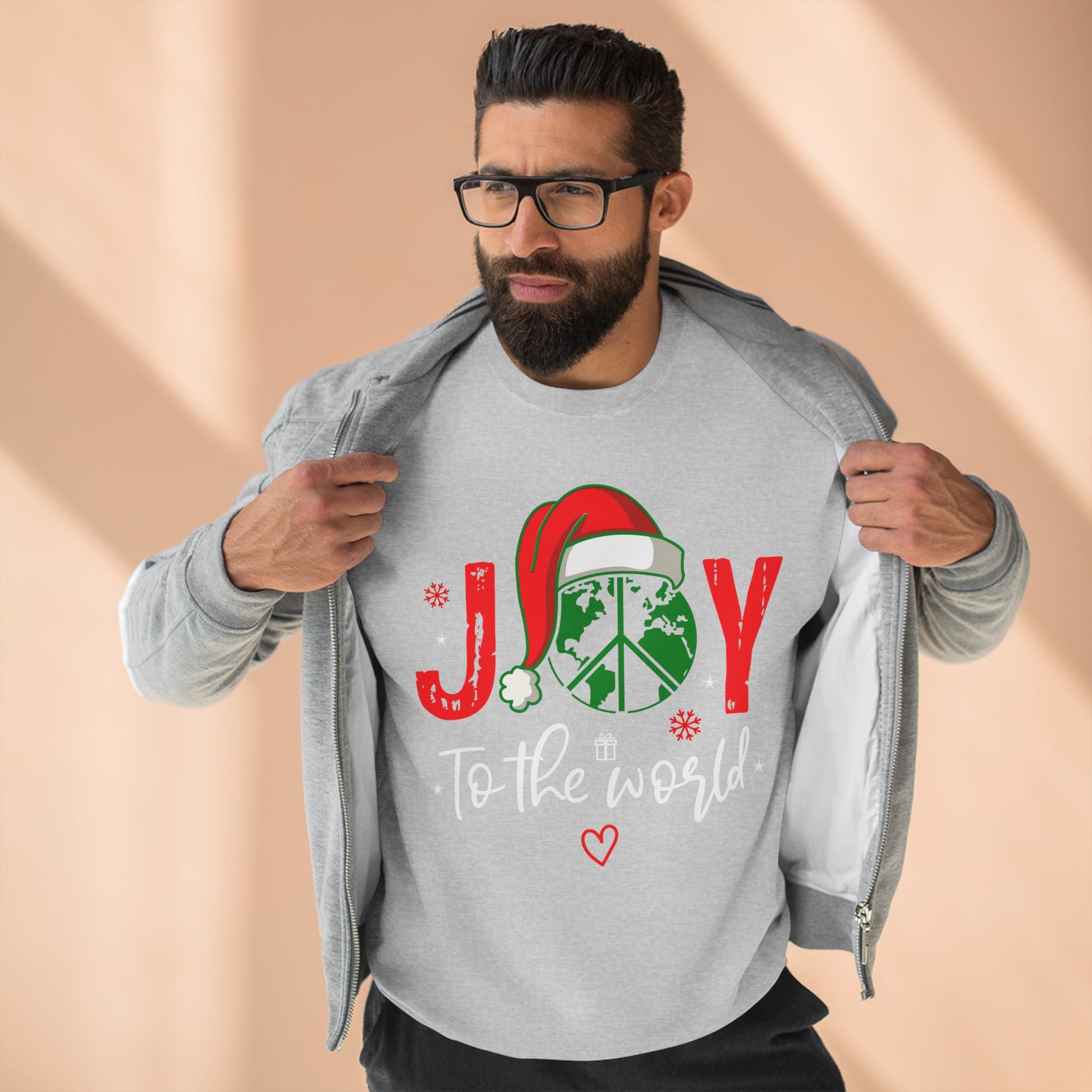 Man wearing a gray sweatshirt with a Christmas design and text on a beige background