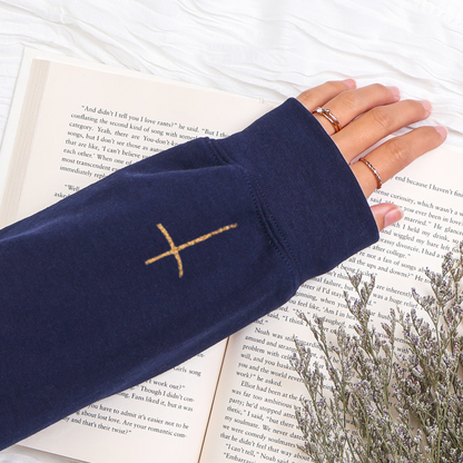 Navy blue sleeve with a gold cross design on a book