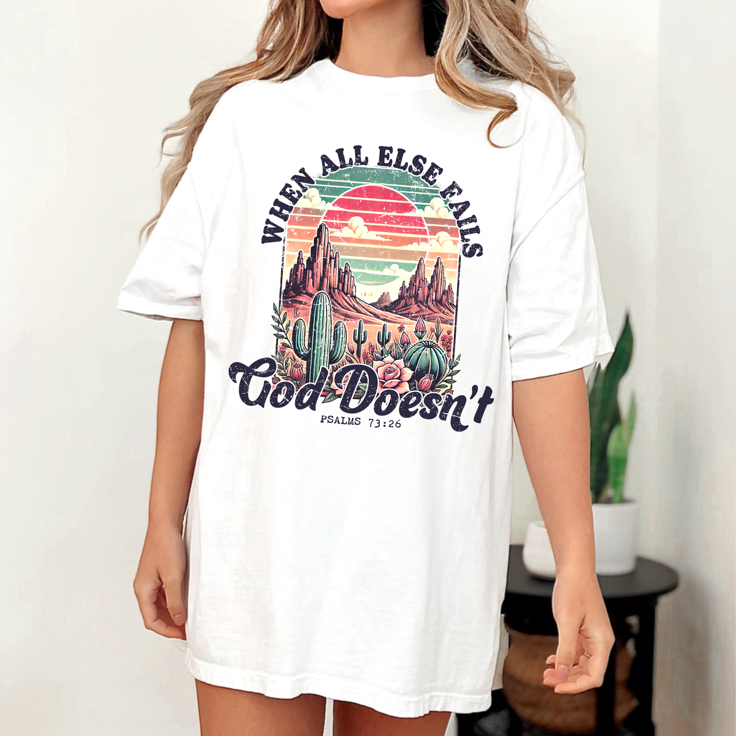 White t-shirt with graphic design and text worn by a person indoors.